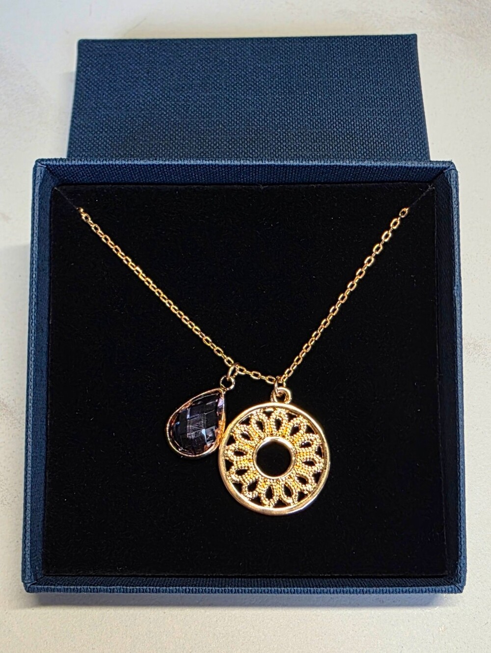 Gold Sunburst Pendant Necklace with Black Teardrop Crystal